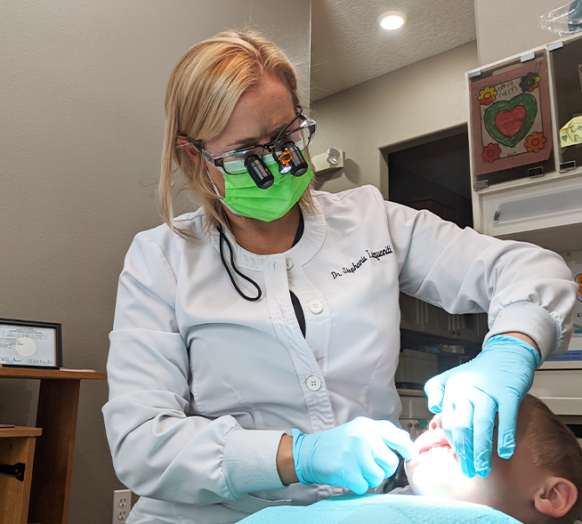 Doctor Lacquaniti performing dental exam