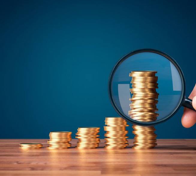 Coins examined with magnifying glass