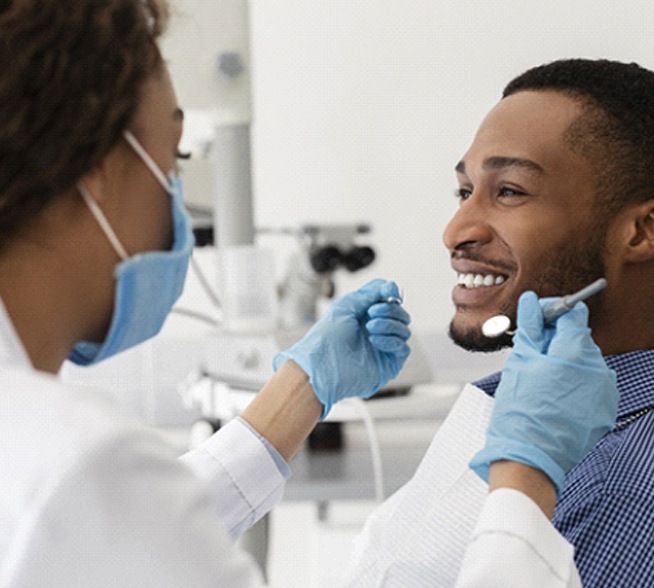 Man discussing dental crowns with his Tyler dentist