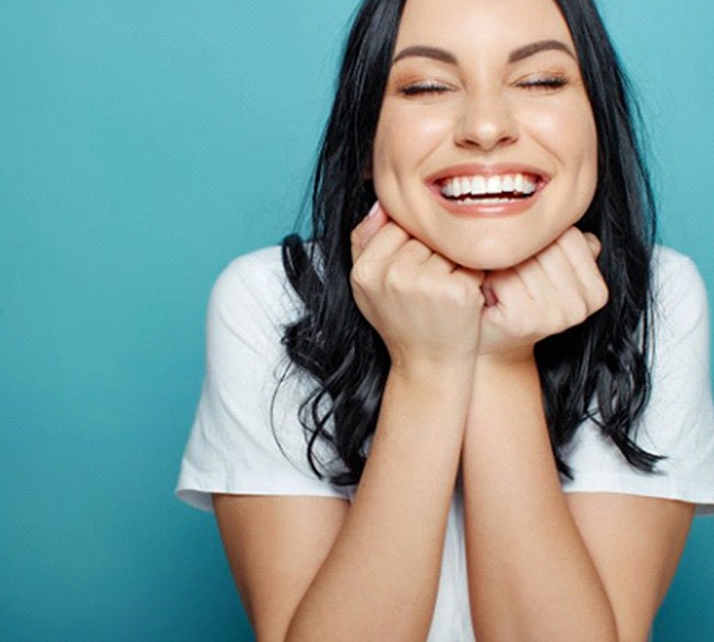 Smiling woman with dental crowns in Tyler