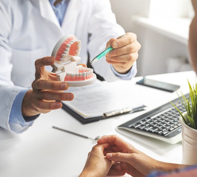 a dentist explaining dentures in Mt. Dora