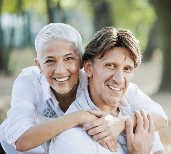 Older man and woman smiling together outdoors