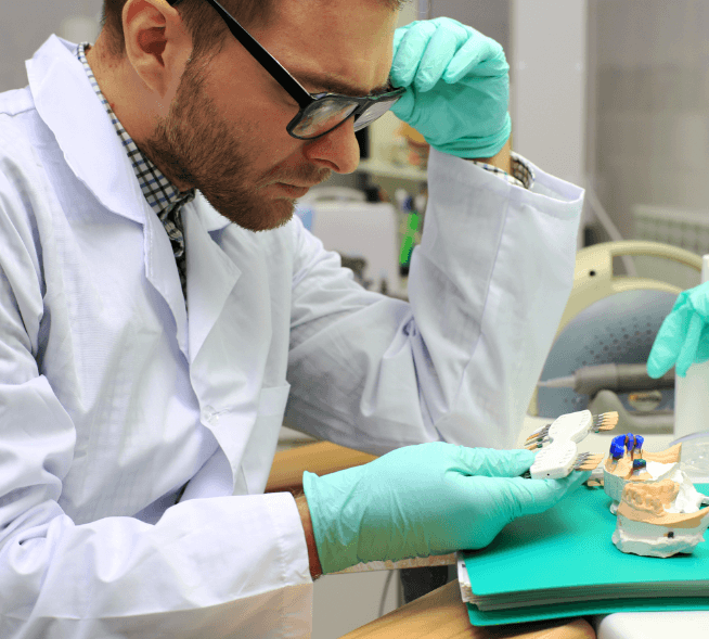 Dental lab technician creating replacement teeth