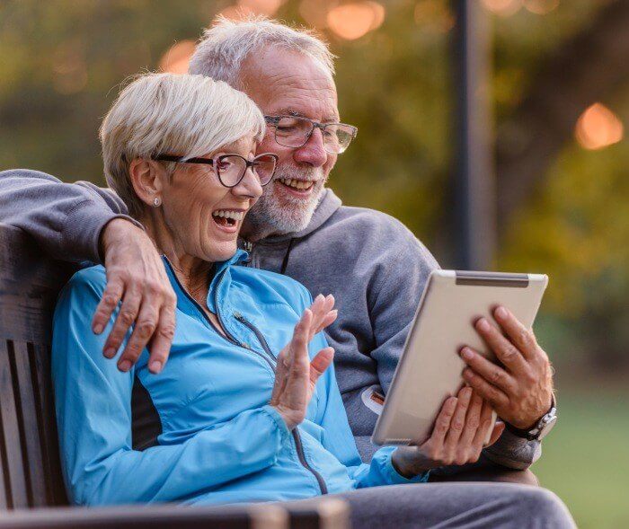 Older couple video chatting on a tablet computer