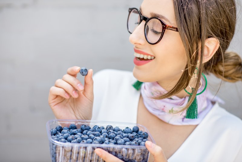 woman eating blueberries after teeth whitening in Mt. Dora