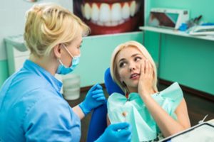 Woman talking with her dentist during an emergency dental visit.