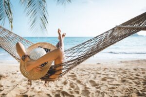 Woman relaxing in hammock. 